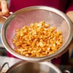 Homemade fried garlic and garlic oil in a glass jar for cooking.